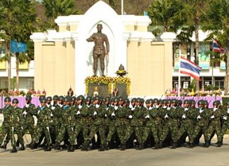 Soldiers parade past the King Naresuan monument in Chonburi.